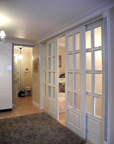 an open door leading to another room with a rug on the floor in front of it