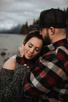 a man and woman embracing each other by the water