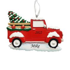 a red truck ornament with a christmas tree in the back and name on it