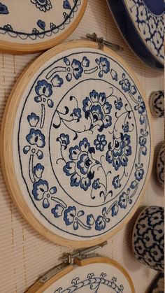 three blue and white plates with flowers on them are sitting next to some other items