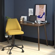 a desk with a laptop computer sitting on top of it next to a chair and lamp