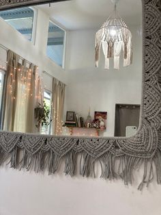 a large mirror with tassels hanging from it