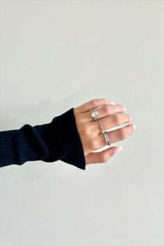 a woman's hand with three rings on it