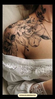 a woman's back with flowers on it and laces around her waist,