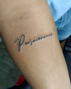 a person with a tattoo on their arm that reads, persevirancee