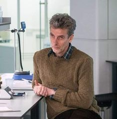 a man sitting at a desk in an office