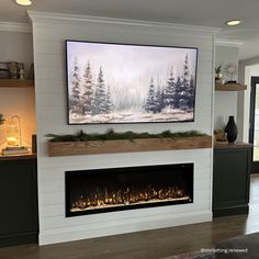 a fireplace with a painting on the wall above it