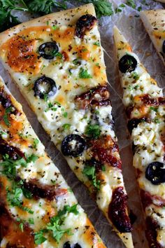 four slices of pizza with olives, cheese and parsley