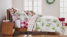 a bed room with a neatly made bed and christmas decorations