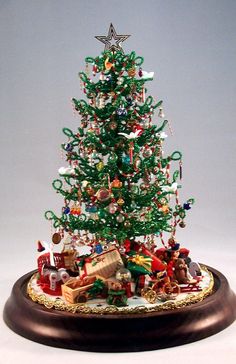 a small christmas tree with many ornaments on it