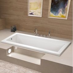 a large white bath tub sitting on top of a counter