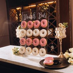 doughnuts are on display in front of a sign that says donuts box