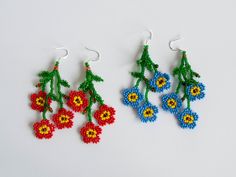 three pairs of beaded earrings with flowers on them