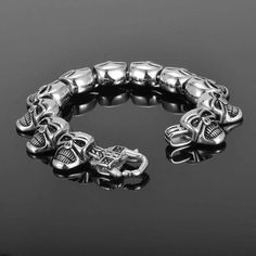 This men’s skull bracelet is edgy, devilish, and expressive. Get ready to be showered with compliments as you show off this iconic steampunk bracelet for men. It is made out of the highest quality stainless steel, which is exquisitely polished. It is given an antique silver finish that compliments your personal style. This skull bracelet is sturdy and lightweight, although feels solid and comfortable on your wrist. ✔ Condition: 100% Brand New and High Quality ✔ Material: Stainless Steel ✔ Color: Edgy Skull-shaped Metal Bracelets, Edgy Skull Metal Bracelets, Gothic Stainless Steel Skull Bracelets, Edgy Metal Skull Bracelets, Gothic Skull Print Bracelets As Gift, Skull Print Metal Jewelry For Streetwear, Punk Stainless Steel Bracelets For Streetwear, Silver Punk Bracelet For Streetwear, Halloween Punk Skull Bracelets