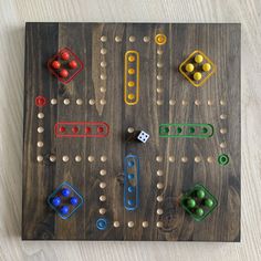 a wooden board game with different colored pieces