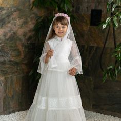 When it comes to a First Holy Communion dress, the veil is an essential element that adds a touch of elegance and tradition. A lace communion dress paired with a delicate lace veil creates a stunning ensemble for this special occasion. The lace communion dress is not only a symbol of purity but also showcases timeless beauty. The intricate lace detailing on the dress adds an extra level of sophistication, making your little one feel like a princess on her big day. Tulle First Communion Dress With Lace Trim, Lace First Communion Dress With Lace Sleeves For Confirmation, Tulle Lace Dress For First Communion, Lace Dress For Confirmation, Tulle Lace Dress With Lace Trim For First Communion, Lace First Communion Dress For Church, Lace First Communion Dress With Lace Trim, First Communion Dress With Lace Trim, White Lace First Communion Dress For Church