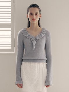 This frill collar knit top is perfect for adding a touch of loveliness to your outfit. It features frill detailing at the neckline and cuffs, exuding feminine mood.- Cropped length that makes your look stylish- Falls slimly on the body with an elastic waistband for a flattering fit- Versatile color for easy everyday wear without feeling burdensome Feminine Fine Knit Winter Tops, Winter V-neck Top With Ruffles, Feminine Winter Tops For Workwear, Feminine Fine Knit Sweater, Feminine Fall Knit Top, Feminine Knit Top For Fall, Elegant Ruffled Knit Top For Spring, Elegant Ruffle Knit Top For Spring, Elegant Spring Ruffle Knit Top