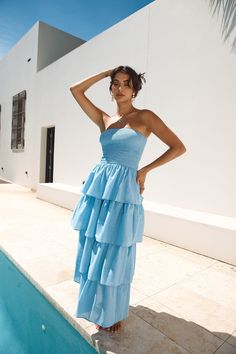 Feel like a modern-day princess in the Glass Slipper Strapless Maxi Dress in Blue. Perfect for whimsical evening soirees as the sunsets. Style silver heels and adornments to radiate elegant energy. Maxi dress. true to size Strapless Stretch ruched bust to waist Tiered skirt Style slips on Semi-lined 100% Cotton. Lining: Rayon Non-stretch material Please refer to the care label on garment for specific instructions on how to care for it Model wears XS Length from bust to hem: 121cm on an S Chest 31cm. Waist 29cm. size S Chic Blue Strapless Beach Dress, Casual Blue Strapless Maxi Dress, Blue Strapless Maxi Dress With Ruffles, Luxury Blue Strapless Maxi Dress, Blue Ruffled Floor-length Maxi Dress, White Slip Dress, Mini Dress Formal, Strapless Maxi, Crop Top Tees