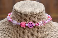 This fun choker is made of a mix of fun pink and white beads randomly strung on choker sized memory wire . **Please note: There is no clasp this choker simply wraps around the neck. See photo.** Adjustable Whimsical Choker, Whimsical Adjustable Choker, Summer Pink Choker As Gift, Pink Adjustable Choker As A Gift, Pink Choker With Colorful Beads For Gift, Pink Round Beads Choker For Festival, Festival Pink Round Beads Choker, Adjustable Pink Trendy Choker, Pink Adjustable Trendy Choker