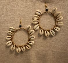 Cowrie Shell hoop earrings are handmade from Nairobi, Kenya  Please Handel with care due to the shells and the brass wire. I suggest putting on any make up and perfume before putting on these earrings. Each shell is unique and there may be a slight variation in size.  Measuring from top of ear hook the earrings are about 3.5-4in long and the width is about 3in Handmade Teardrop Hoop Earrings For Beach, Handmade Shell Hoop Earrings For Beach, Handmade Shell Bohemian Hoop Earrings, Bohemian Handmade Shell Hoop Earrings, Handmade Hoop Earrings For The Beach, Beach Hoop Earrings Wire Wrapped, Beach Hoop Earrings With Wire Wrapping, Beach Wire Wrapped Hoop Earrings, Handmade Gold Shell Hoop Earrings