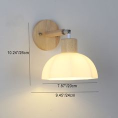 the wall light is made from wood and has a white shade on it's side