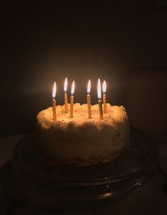 a birthday cake with lit candles on it