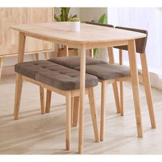 a wooden table with two chairs next to it