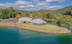 an aerial view of a house on the water