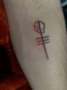 a small tattoo on the arm of a person with a fork and spoon in it