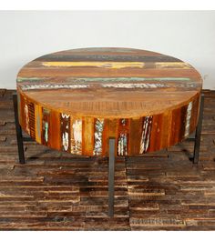 a round wooden table sitting on top of a hard wood floor