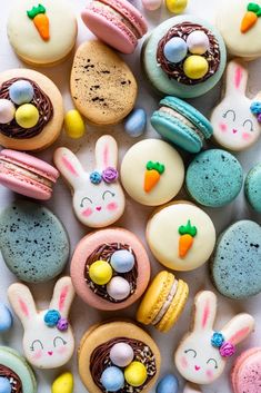 an assortment of decorated cookies and pastries in the shape of bunnies, eggs, carrots, and birds