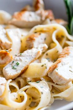 a white plate topped with pasta and chicken