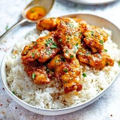 a white plate topped with rice and chicken