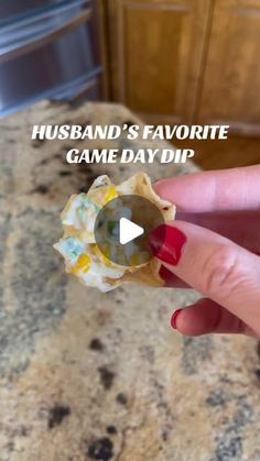 a person holding a piece of food with the words husband's favorite game day dip