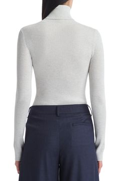 Soft ribbing lends a close fit to this layer-perfect turtleneck sweater knit from pure merino wool. 23" length Turtleneck Long sleeves 100% merino wool Dry clean Made in the USA Workwear Fine Knit Funnel Neck Sweater, Fine Knit Funnel Neck Sweater For Work, Elegant Long Sleeve Turtleneck With Ribbed Neckline, Fitted Knit Top With Ribbed Collar For Work, Workwear Funnel Neck Sweater With Ribbed Neckline, Elegant Ribbed Merino Wool Tops, Fitted Fine Knit Turtleneck Sweater, Fitted Fine Knit Turtleneck Top, Classic Fitted Knit Top For Winter