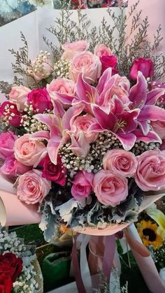 a bouquet of pink roses and other flowers