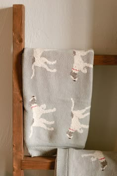 two towels sitting on top of a wooden chair