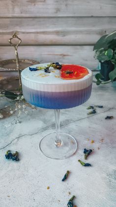 a blue and white dessert sitting on top of a table next to a potted plant