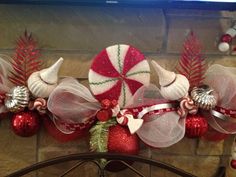 a fireplace with christmas decorations and candy canes