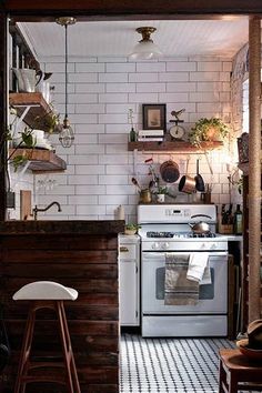 a kitchen with an oven, stove and stools