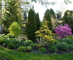 the garden is full of colorful flowers and trees