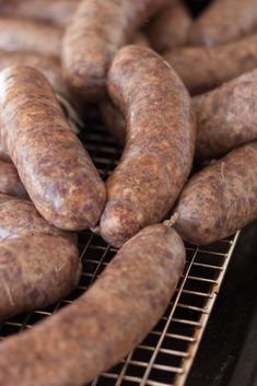 some sausages are on a grill and ready to be grilled in the oven