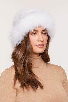 Two supreme furs in one elegant hat give your winter wardrobe an upgrade. Our Knitted Danish mink fur tails hat is framed at the brim with a fluffy Finnish blue fox fur ruff for a feminine finish. Warm, soft, and lightweight, this pretty hat perks up winter days and nights while insulating you from the cold. White Fur Felt Winter Hat, White Fur Felt Hat For Winter, Winter Fur Felt Hats With Faux Fur Lining, Winter Hat With Feather Trim, Fluffy Faux Fur Hat For Fall, Faux Fur Beanie Hats For Fall, Faux Fur Beanie For Fall, Fall Faux Fur Beanie Hat, Fluffy Faux Fur Hat For Cold Weather