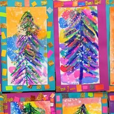 four colorful christmas trees painted on paper