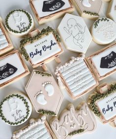 baby shower cookies are arranged on a table