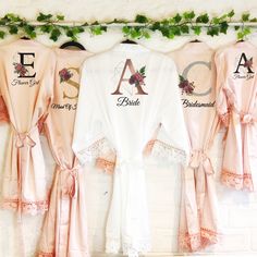 three robes hanging up on a wall with the letters a, b, and c