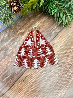 a red and white beaded triangle ornament