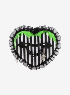 a black and white heart shaped purse with green accents