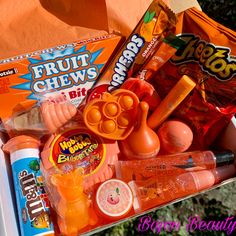 an orange box filled with candy and candies