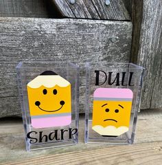 two clear acrylic signs with faces and words that spell out dull, sharp